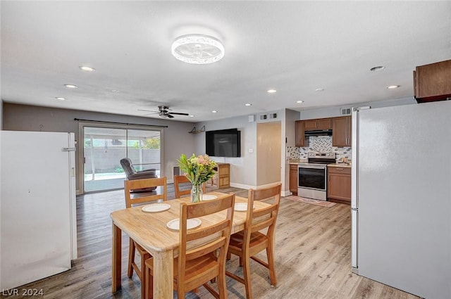 dining space with ceiling fan and light hardwood / wood-style floors