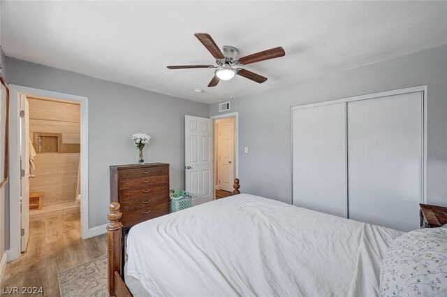 bedroom featuring ceiling fan, a closet, and light hardwood / wood-style floors