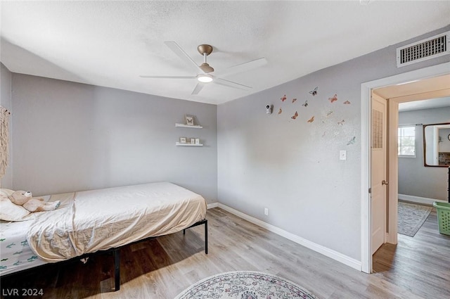 bedroom with ceiling fan and light hardwood / wood-style floors