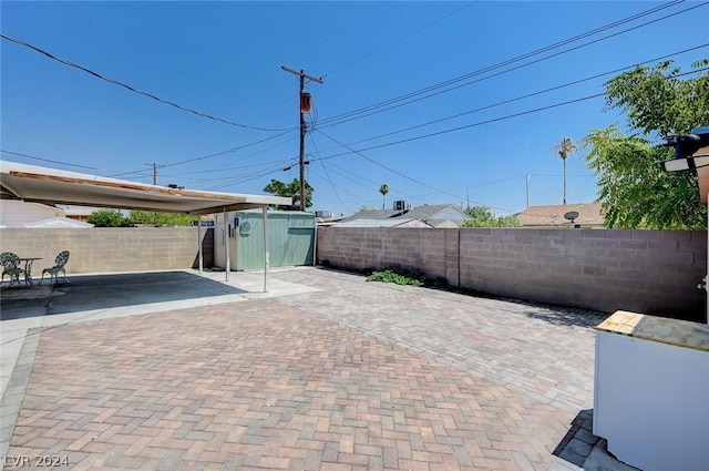 view of patio featuring a storage shed