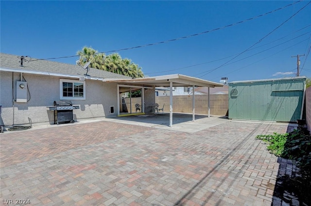 rear view of house with a storage unit