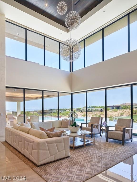 living room with a high ceiling and a chandelier