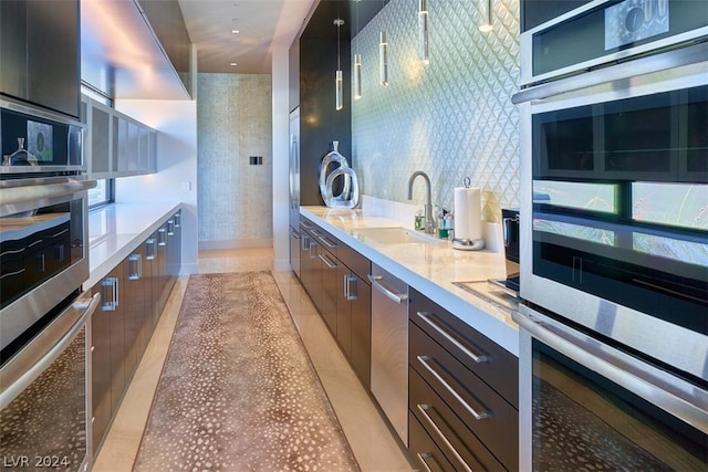 kitchen with sink, light tile patterned floors, stainless steel double oven, and tasteful backsplash