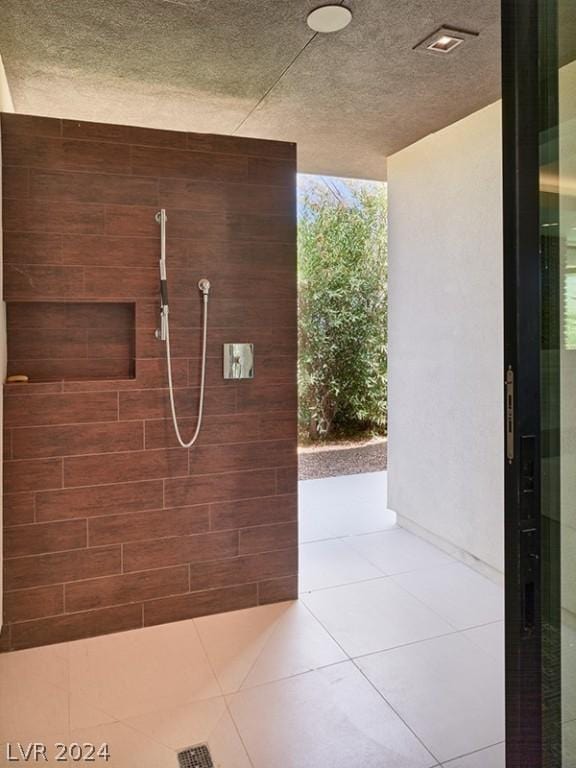 bathroom with a shower and tile patterned floors