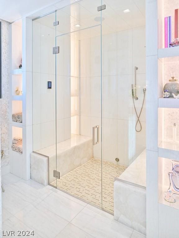 bathroom featuring a shower with shower door