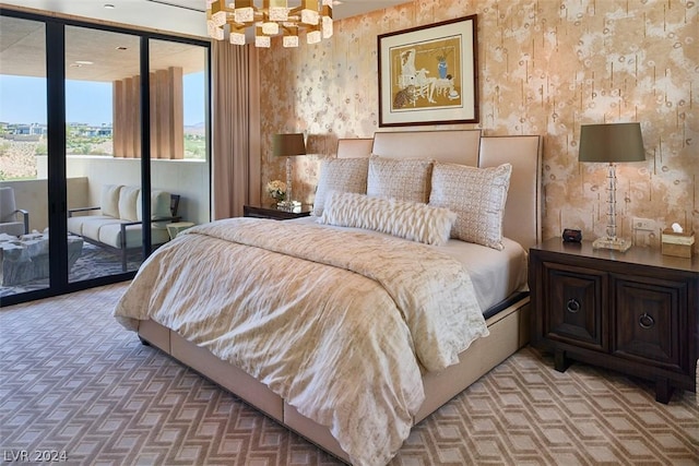 bedroom with a notable chandelier and access to exterior