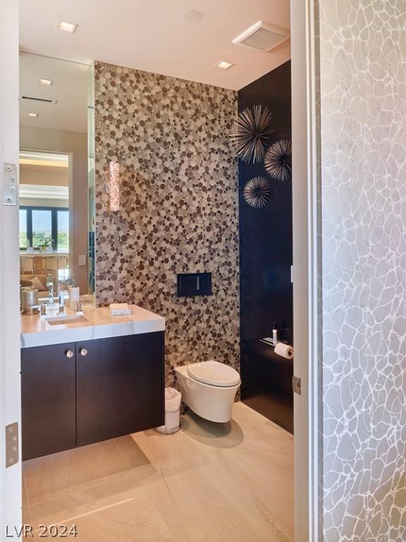 bathroom with toilet, tile patterned flooring, and vanity