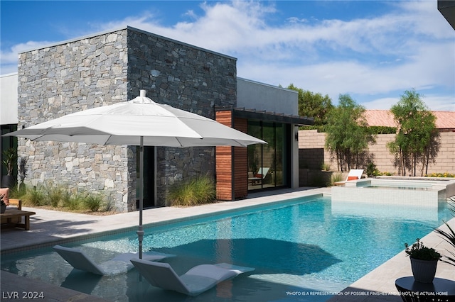 view of swimming pool featuring an in ground hot tub