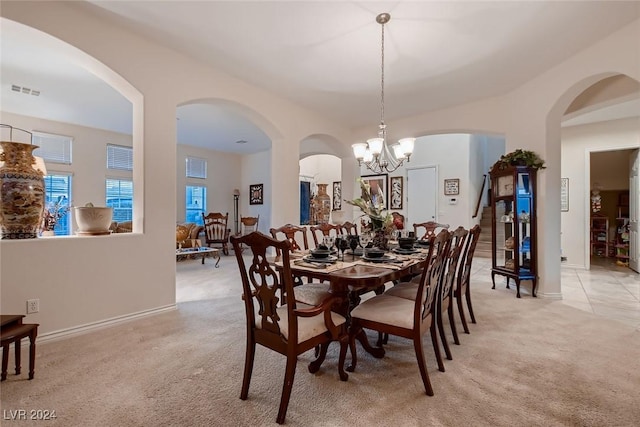 dining area with light carpet, visible vents, and baseboards