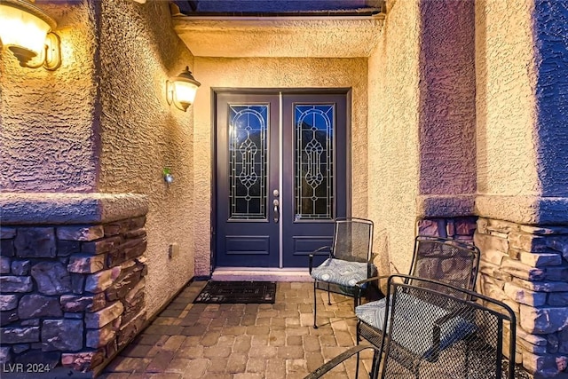 doorway to property with stucco siding