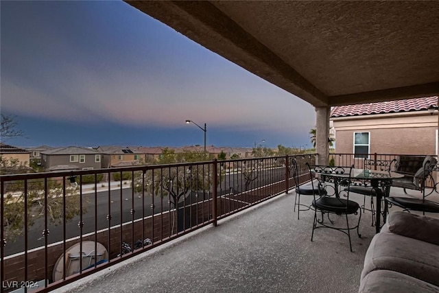 balcony with a residential view and outdoor dining space