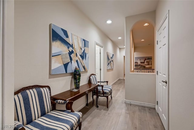 corridor with baseboards, wood finished floors, and recessed lighting