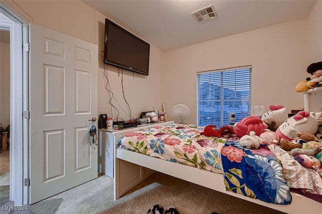 carpeted bedroom featuring visible vents