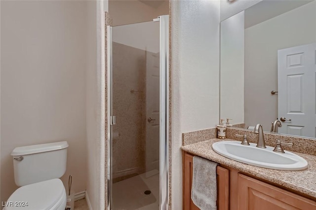 full bathroom with toilet, a stall shower, and vanity