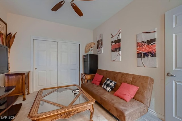 living room featuring a ceiling fan and carpet flooring