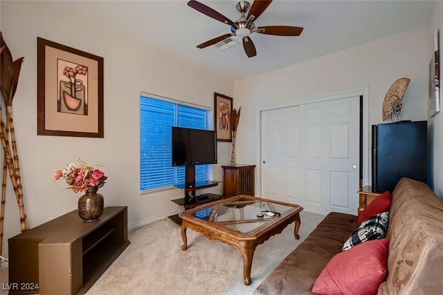 living area featuring ceiling fan and carpet flooring