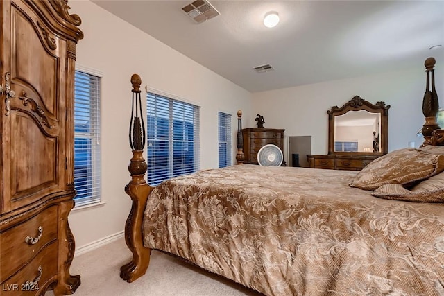 carpeted bedroom featuring baseboards and visible vents