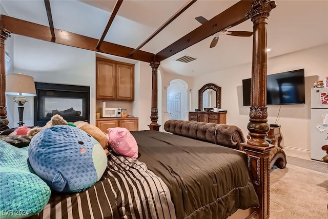 bedroom featuring arched walkways, light carpet, visible vents, freestanding refrigerator, and beam ceiling