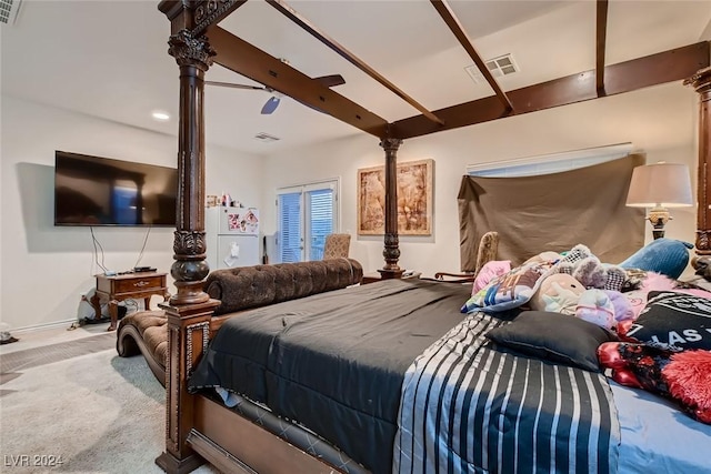 bedroom featuring beam ceiling, visible vents, freestanding refrigerator, carpet flooring, and baseboards