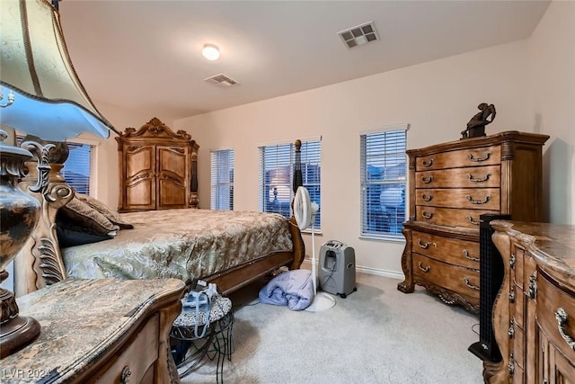 bedroom with carpet, visible vents, and baseboards