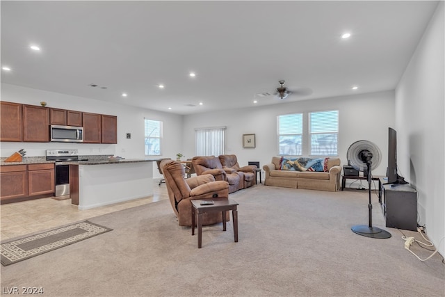 living area featuring recessed lighting, a wealth of natural light, and light colored carpet