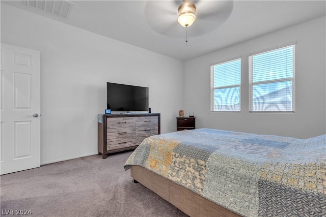 carpeted bedroom featuring baseboards, visible vents, and a ceiling fan