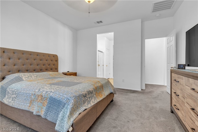 bedroom featuring baseboards, visible vents, a ceiling fan, and light colored carpet