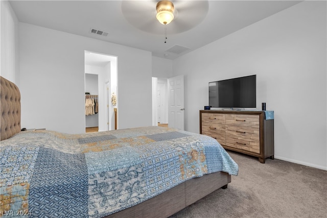 carpeted bedroom featuring a ceiling fan, visible vents, and baseboards