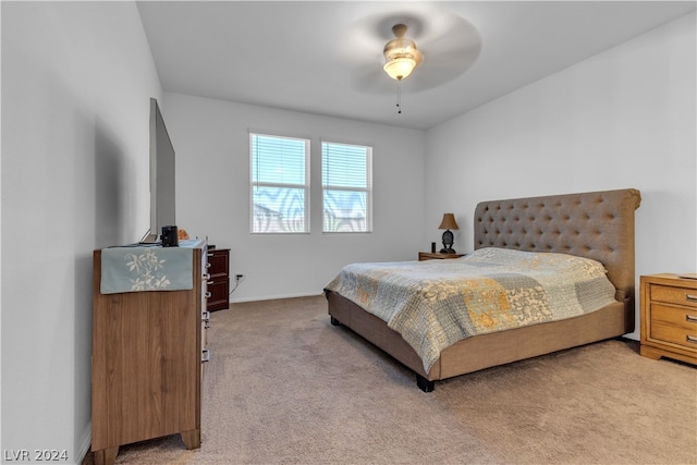 bedroom with baseboards, a ceiling fan, and light colored carpet