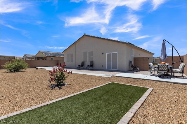 back of property with a patio, fence, a tiled roof, and stucco siding