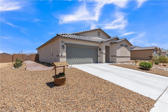 mediterranean / spanish-style home featuring driveway, a tile roof, an attached garage, fence, and stucco siding