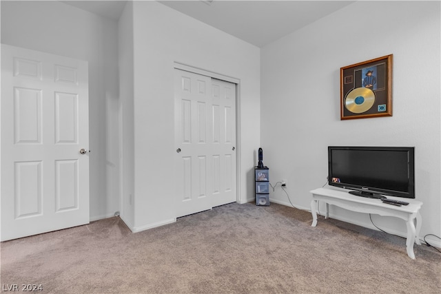 carpeted bedroom with a closet and baseboards