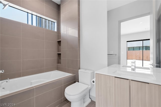 full bathroom featuring tiled shower / bath combo, vanity, toilet, and tile patterned floors