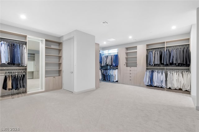 unfurnished bedroom with light carpet and two closets