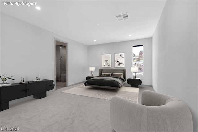 carpeted bedroom featuring ensuite bath