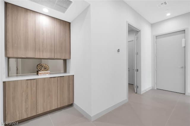 hallway featuring light tile patterned floors