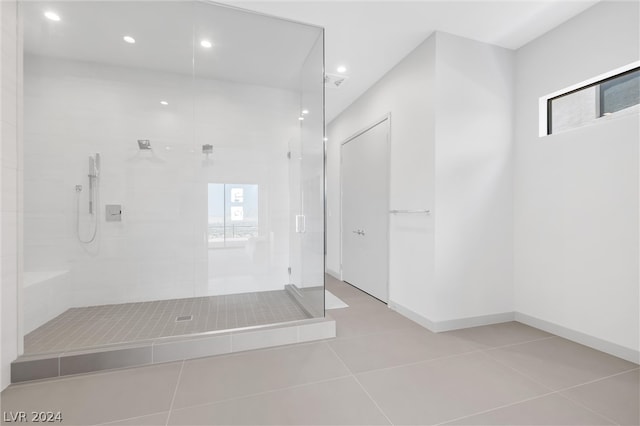 bathroom featuring tile patterned floors and a tile shower