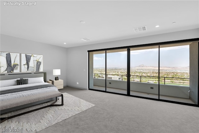 bedroom with multiple windows, access to outside, and light colored carpet