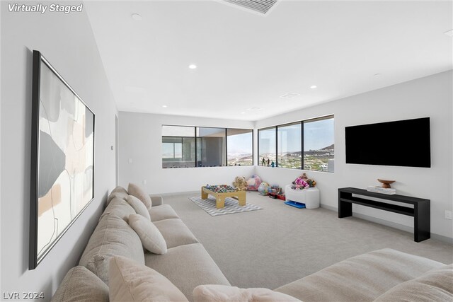 living room with a healthy amount of sunlight and light colored carpet