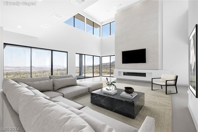 living room with a towering ceiling