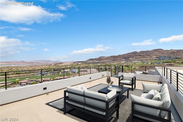 view of patio / terrace featuring outdoor lounge area, a mountain view, and a balcony