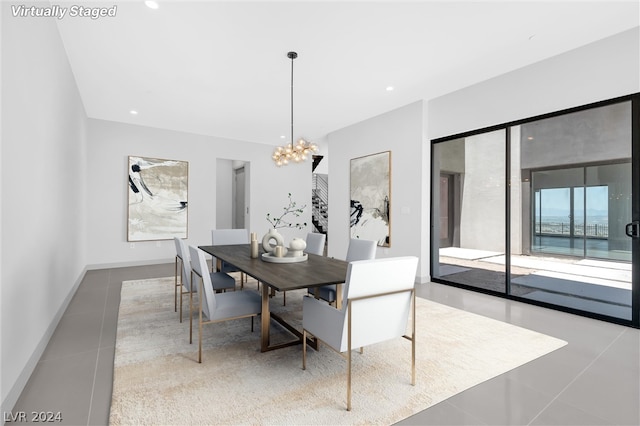 tiled dining area with a chandelier