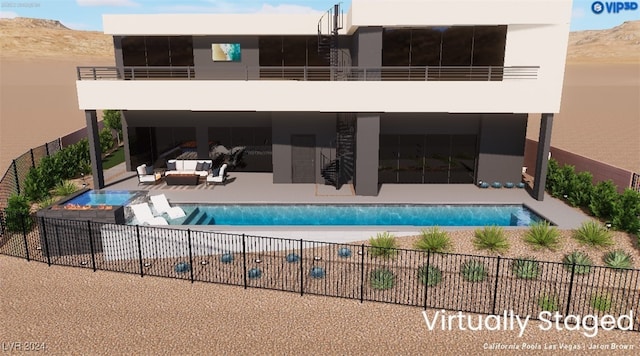 view of swimming pool with a mountain view and a patio