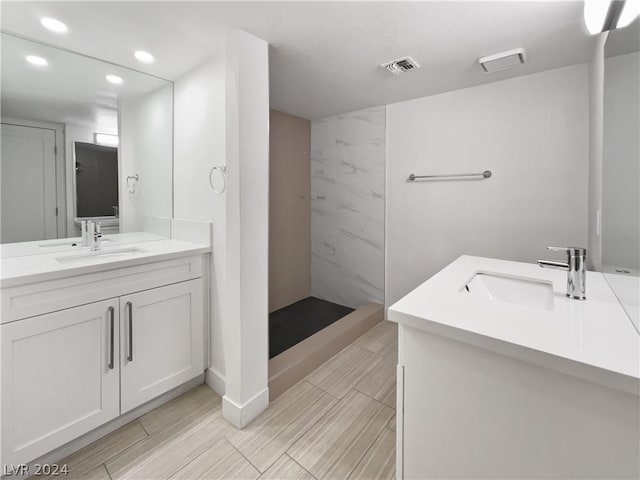 bathroom with walk in shower and vanity