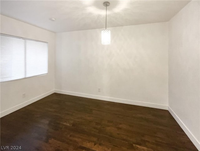 empty room featuring dark hardwood / wood-style flooring