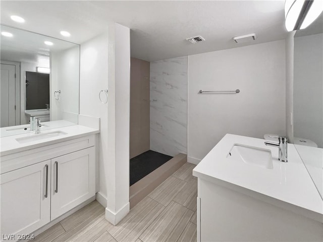 bathroom featuring a shower and vanity