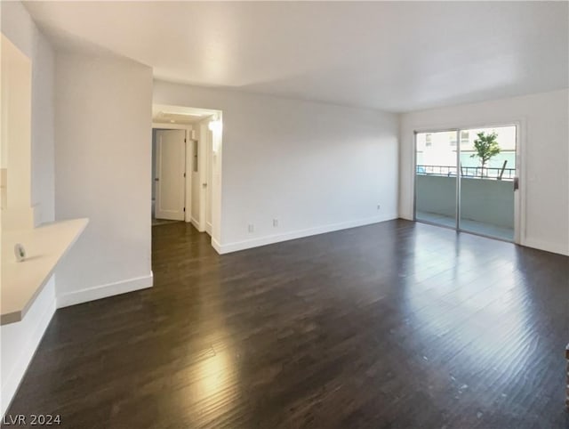 unfurnished living room with dark hardwood / wood-style flooring