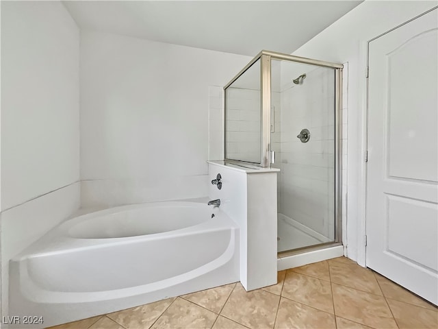 bathroom with shower with separate bathtub and tile patterned floors