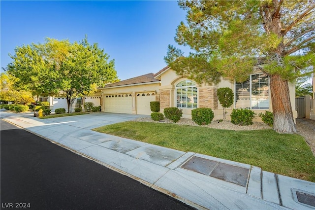 view of front facade with a garage and a front yard