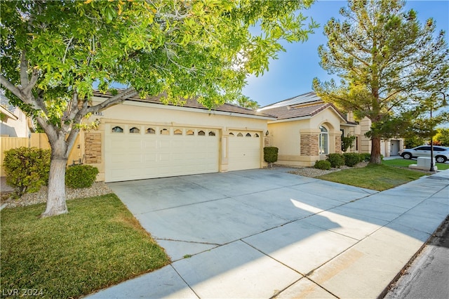 ranch-style house with a garage, a front lawn, and solar panels